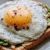 a breakfast sandwich with an egg on top
