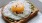 a breakfast sandwich with an egg on top